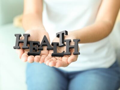 Woman holding black letters, closeup. Health care concept